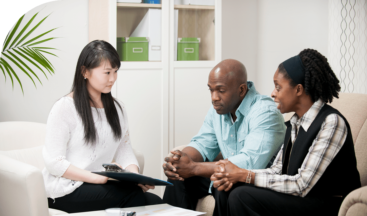 Office meeting with advisor and couple.