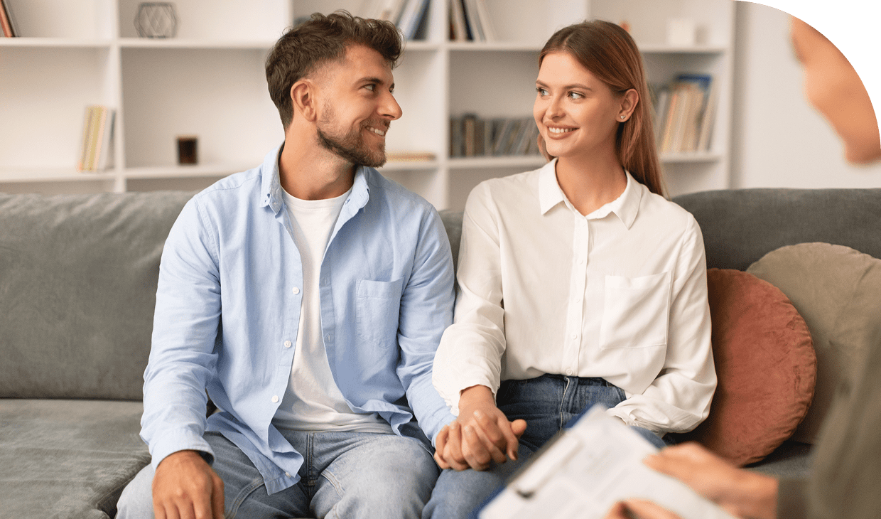 Couple holding hands on couch