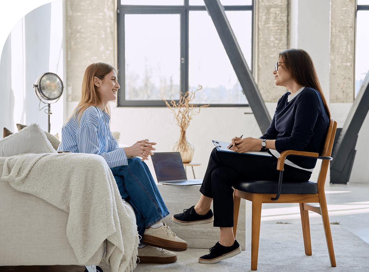 Two women having a conversation indoors.