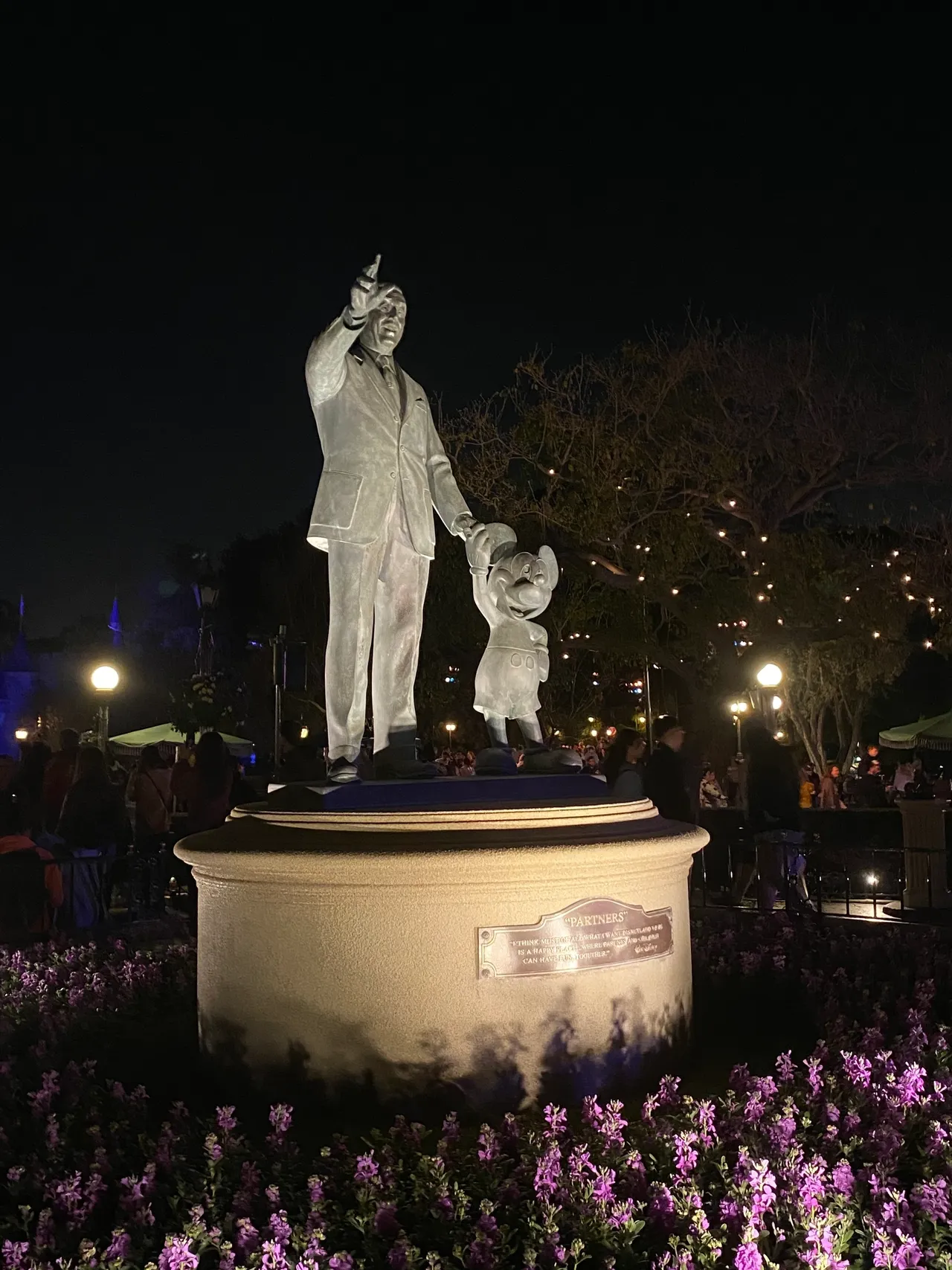 Bronze statue surrounded by colorful blossoms