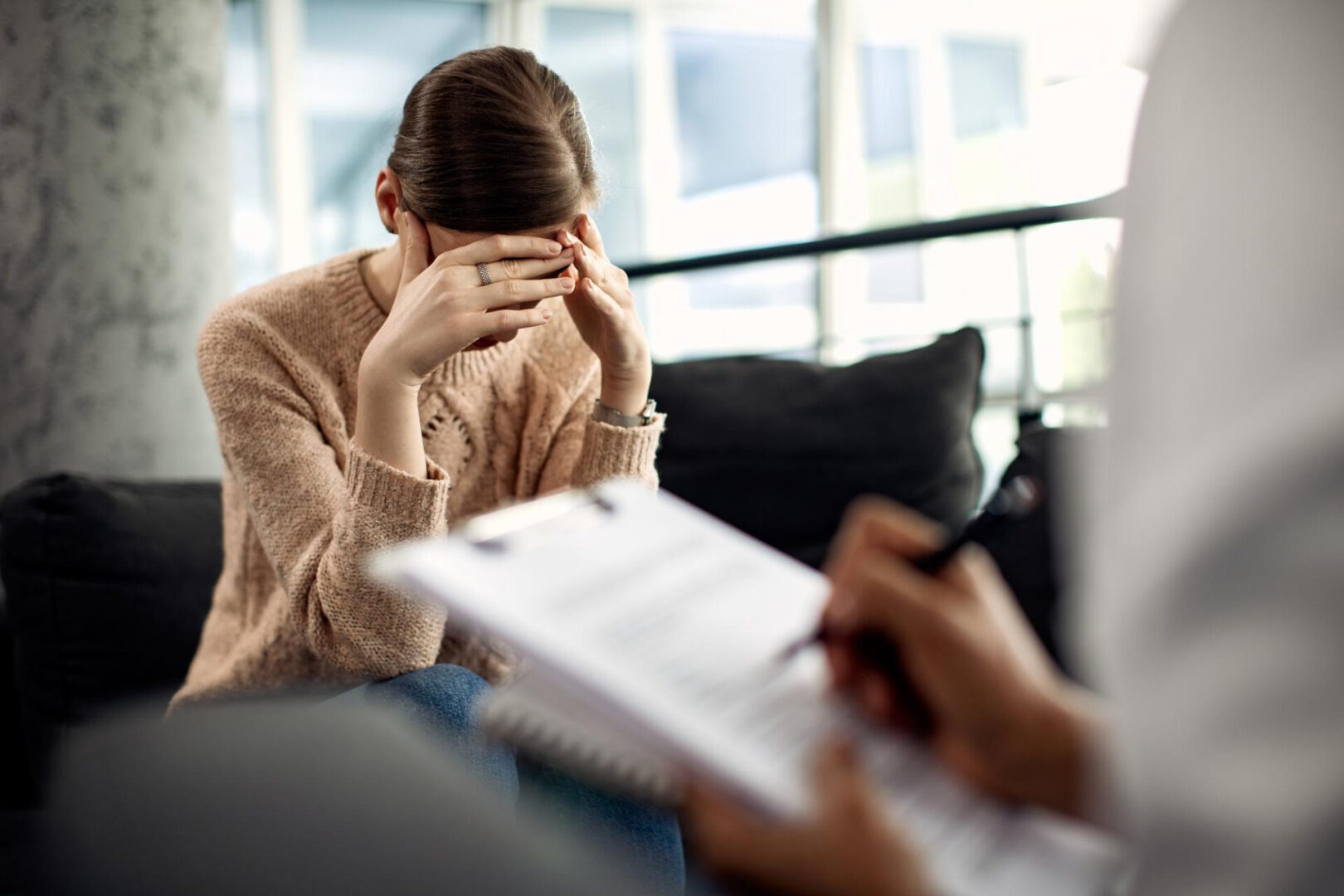 Woman in therapy covering her face