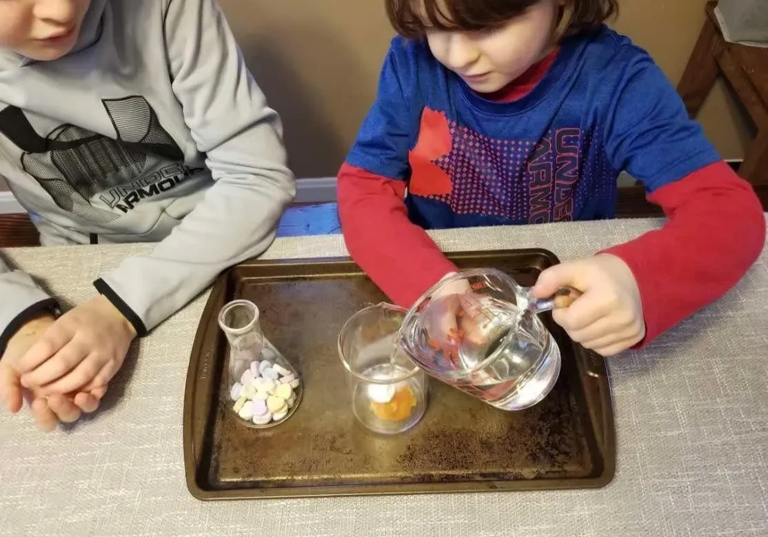 Children conducting a science experiment with water